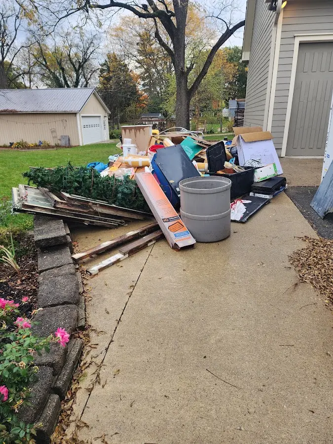 Dumpster being loaded with debris for 10 Yard Dumpster Rental in Troy